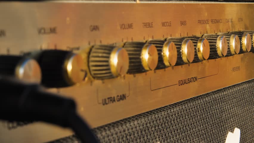 Close-up of the tone knob and power button on the guitar amplifier. A classic guitar combo on a concert stage Royalty-Free Stock Footage #1108334963