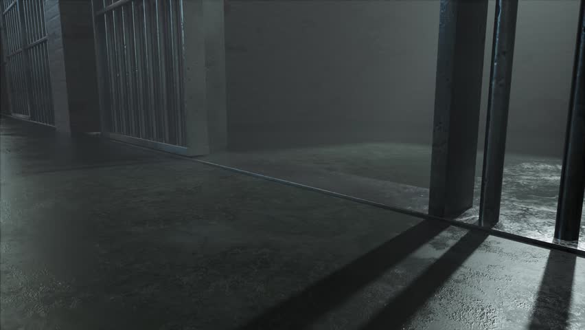 A slow camera pan closeup showing a dimly lit concrete floor of a prison cell and the cast shadows of the jail cell door slamming shut Royalty-Free Stock Footage #1108336303