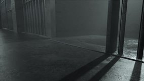 A slow camera pan closeup showing a dimly lit concrete floor of a prison cell and the cast shadows of the jail cell door slamming shut - Powered by Shutterstock - Get 15% off with code: PIKWIZARD15