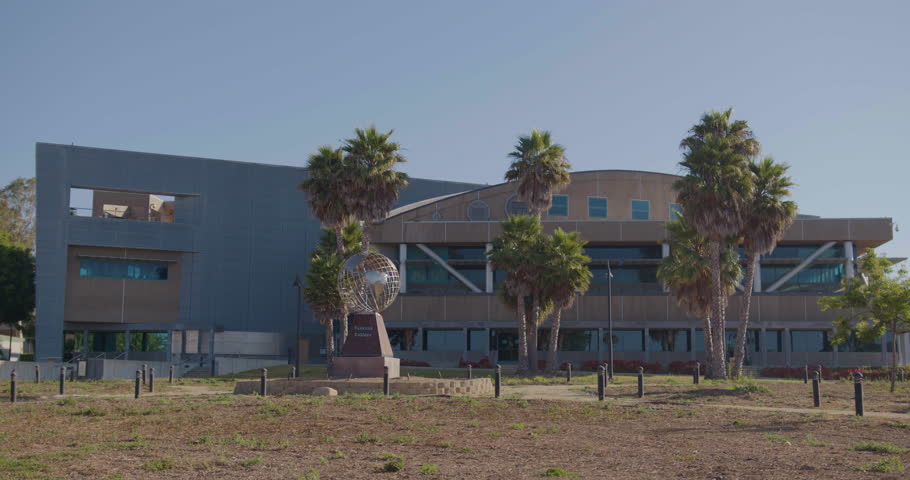 VENTURA, CA - 07.28.2023 - Establishing zoom shot of a large corporate headquarters or university campus administration building with globe statue. | Shutterstock HD Video #1108343895