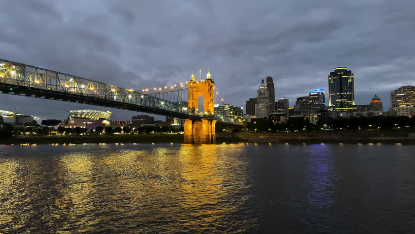 Illuminated John A. Roebling Suspension Bridge At Night In Covington, Kentucky, USA. Wide Shot