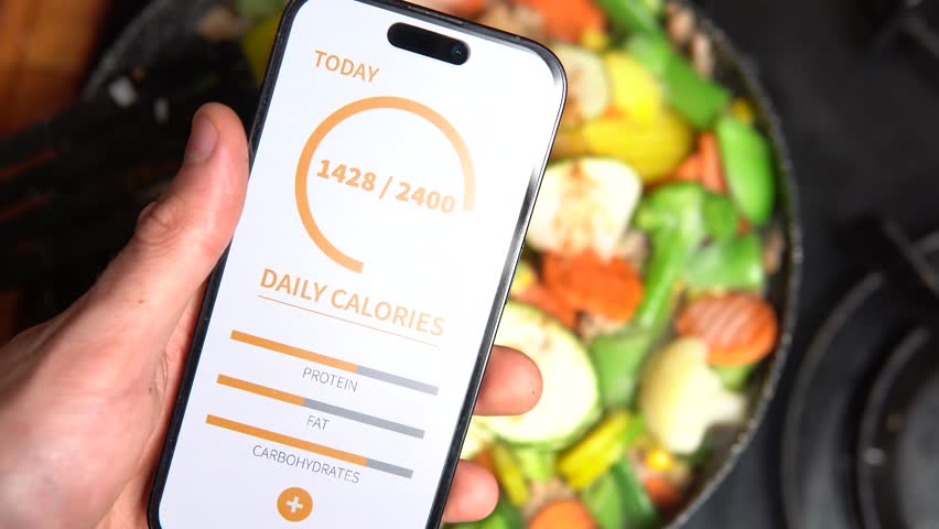calorie counting app with pan background full of healthy food. preparing healthy food and keeping fit Royalty-Free Stock Footage #1108345703