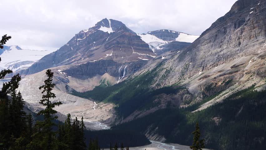 Looking out over the bright blue Peyto Lake with surrounding mountains and forests in Banff National Park, Alberta, Canada. Glacial lake in the Canadian Rockies. 