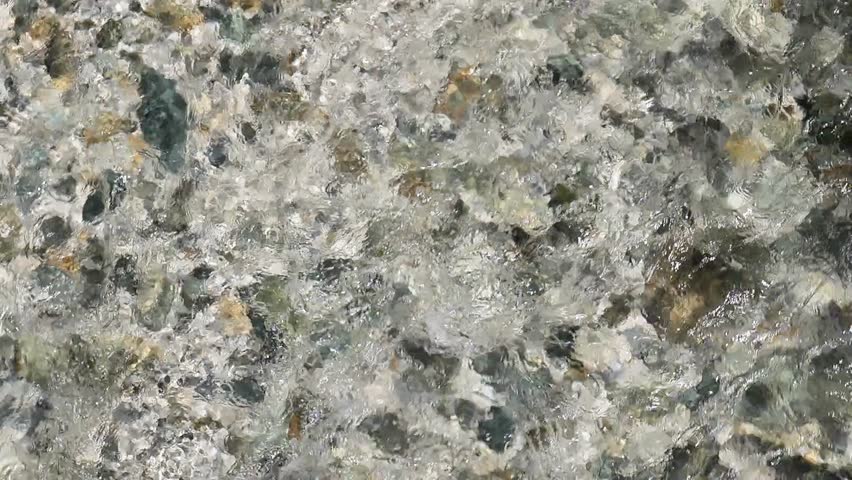 clear water flow background.Clear water.Cristal clear river with pebbly rocky bottom. Texture of water and stone.Clean water concept 4k footage