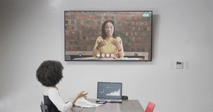 African american businesswoman on video call with african american female colleague on screen. Online connections, business and networking concept.
