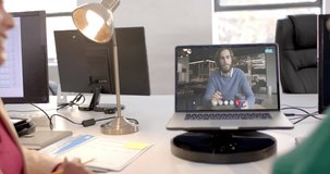 Laptop video call with caucasian male colleague on screen. Online connections, business and networking concept.