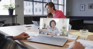 Caucasian businessman on laptop video call with african american female colleague on screen. Online connections, business and networking concept.