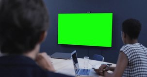 Diverse business people on video call with green screen. Online connections, business and networking concept.