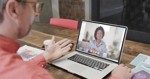 Caucasian businessman on laptop video call with african american female colleague on screen. Online connections, business and networking concept.