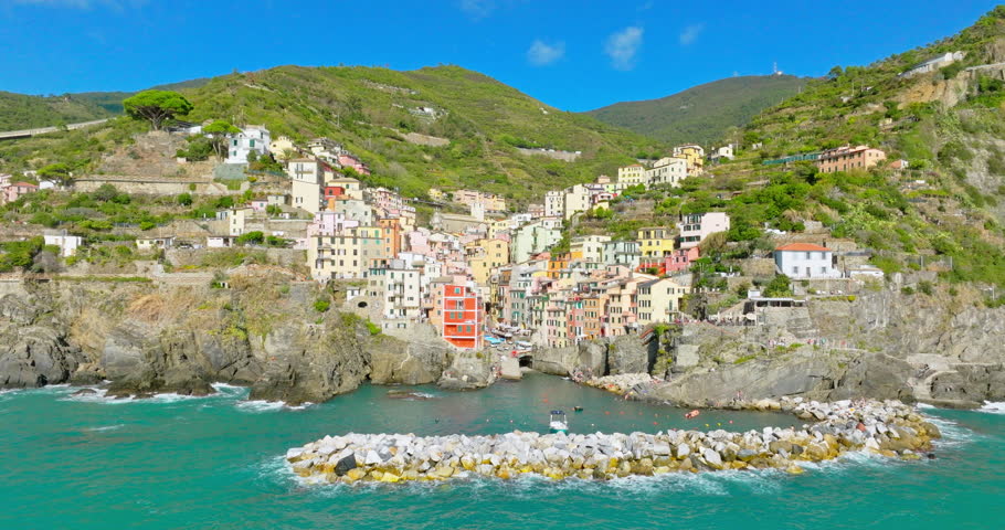 Aerial drone landscape of Riomaggiore, Italy Colorful Cliffside Town the Seaside Mountainous of famous Cinque Terre, Liguria, Northern Italia on Tyrrhenian sea in summer day. Coastal travel village. Royalty-Free Stock Footage #1108353929