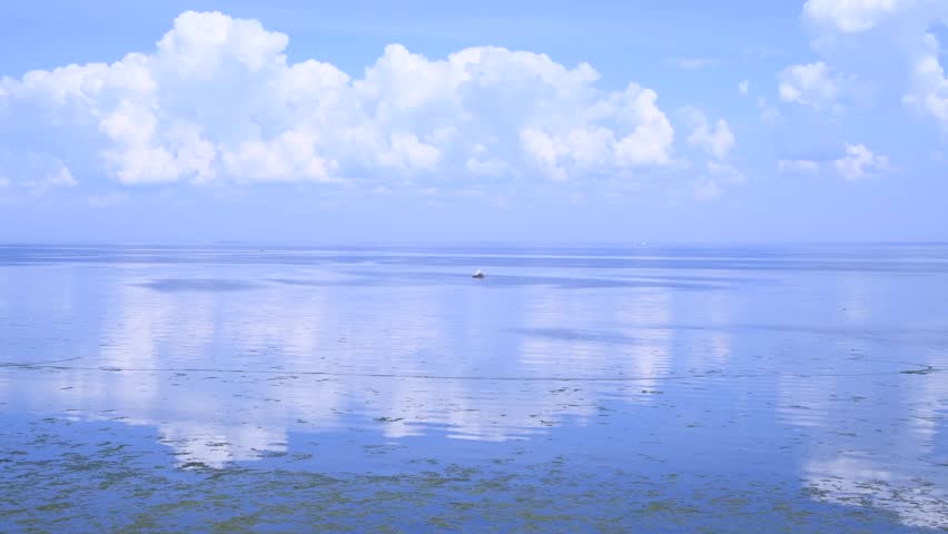 Beautiful day seascape. Surface of water covered with small waves. Blue sky with white clouds reflects in calm water. Abstract summer natural background. Real time video. Copy space. Vacation theme. | Shutterstock HD Video #1108354603