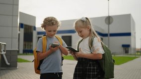 Caucasian Little Kids With Mobile Gadgets In School Break, Portrait Outdoors, School Boy And Girl