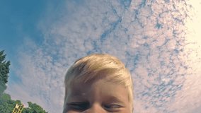Slow motion POV video. Father throws son up when they play on the beach