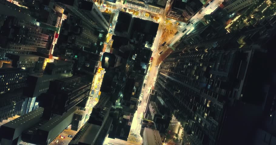 AERIAL. Top view of Hong Kong city at night time. Sky scrappers shot from a drone.
