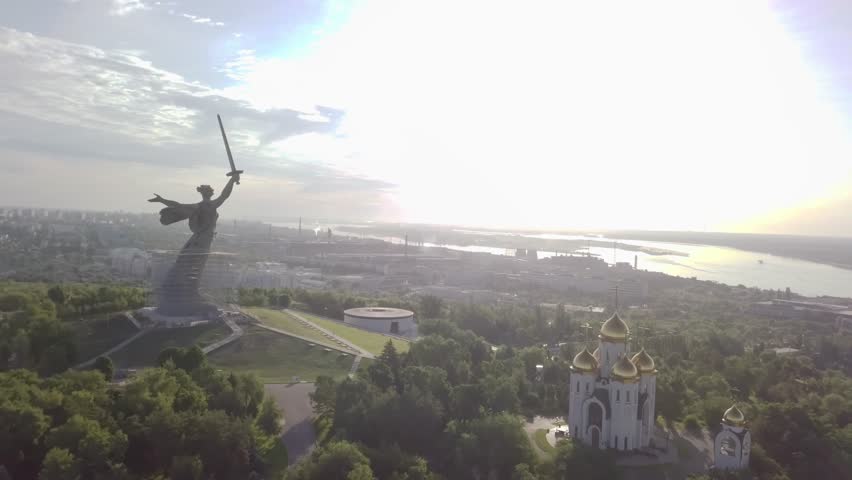 Aerial shot flying past The Motherland Calls and over All Saints Church at the Mamayev Kurgan. View out to the Volga River in Volgograd, Russia. Royalty-Free Stock Footage #1108369257