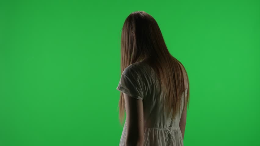 Medium half turn green screen, chroma key video of a posessed female figure, ghost, poltergeist, zombie raising, pulling out a knife, stabbing the air. Chroma key.
