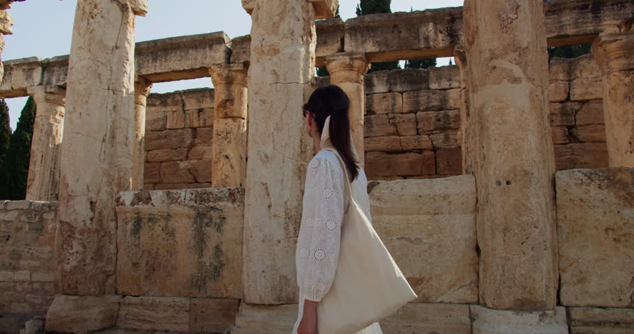 Young woman have cultural journey, explores the breathtaking ruins of Hierapolis ancient town, Turkey