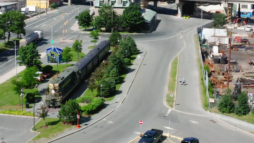 Drone flight towards the Railway Coastal Museum which is a transport museum and has a train in the yard and the harbor in St. John