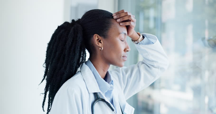 Black woman, doctor and stress in healthcare with headache, frustrated and unhappy with burnout at hospital. Tired, fail and mistake, surgeon is sad or angry, thinking about health crisis and regret Royalty-Free Stock Footage #1108380357