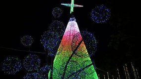 lights decorating the tree in the central square. giant christmas tree. town square with christmas tree. end of the year decoration. giant star tree. christmas illumination. Full HD and 30 FPS video. 