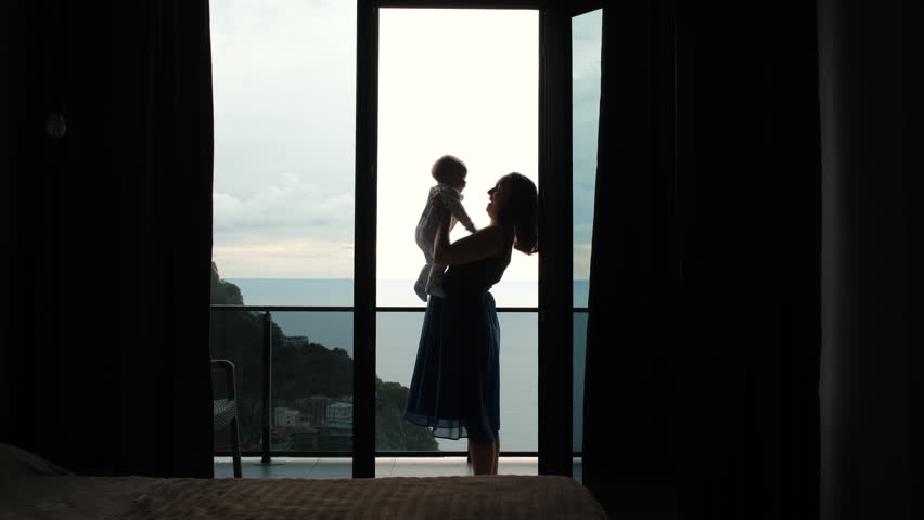 Young woman with her cute baby enjoying sea view from the balcony of hotel room, slow motion. Family vacation and travel concept Royalty-Free Stock Footage #1108383571