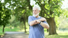 Senior active gray haired bearded man suffers from sharp pain in his shoulder during a morning jog workout in urban city park. Mature old male was injured and rubs massages muscles on the sore spot - Powered by Shutterstock - Get 15% off with code: PIKWIZARD15