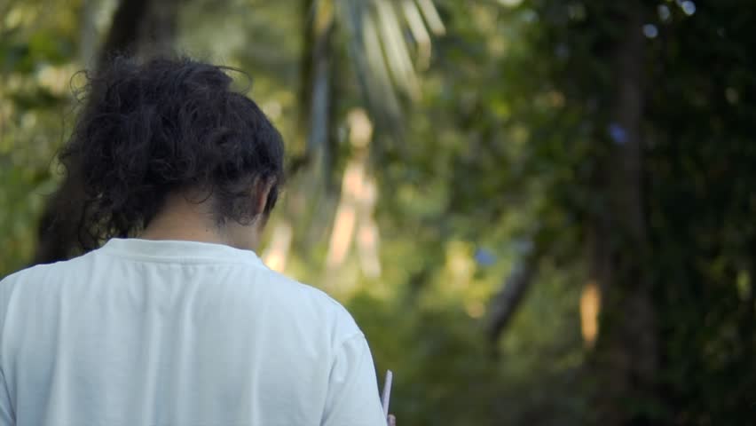Slow motion shot of a girl walking away in the woods in the white shirt - Sexy girl walking in the forest