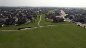Aerial video of Rosewood, Saskatoon, SK, showcasing its modern subdivisions, green spaces, and interconnected streets. A rapidly-growing neighborhood epitomizing suburban innovation.