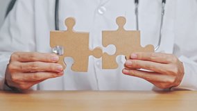 Doctor hand connecting couple puzzle piece, wooden jigsaw in hospital. Teamwork, Idea, Solution, challenge, success, Health, Medical and strategy concepts - Powered by Shutterstock - Get 15% off with code: PIKWIZARD15