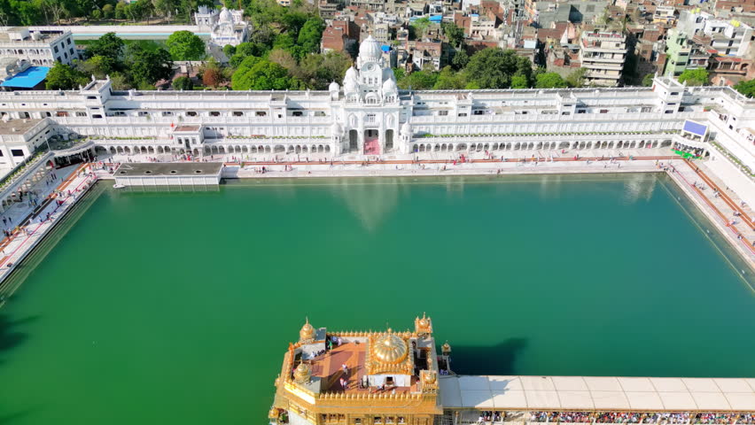 Amritsar, India: Aerial view of famous city in Punjab, iconic landmark The Golden Temple (Harimandir Sahib) - landscape panorama of South Asia from above