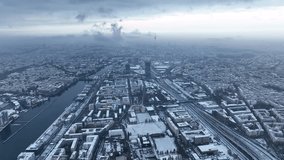 City of Berlin, Germany from above. Aerial winter cityscape view showing architectural landmarks Oberbaum Bridge, TV Tower and Berlin Cathedral in winter. A dark, dramatic urban landscape in grey-blue