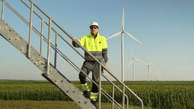 Engineer with a laptop stands on the stairs of a wind turbine - Powered by Shutterstock - Get 15% off with code: PIKWIZARD15