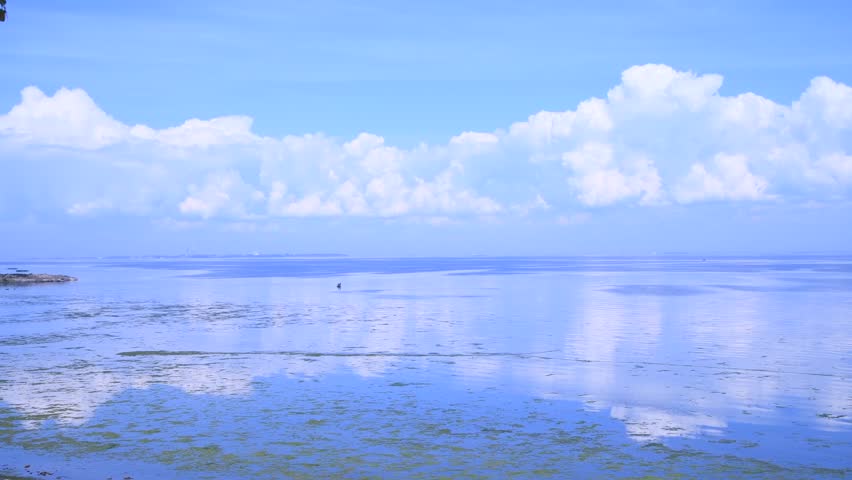 Beautiful day seascape. Surface of water covered with small waves. Blue sky with white clouds reflects in calm water. Abstract summer natural background. Real time video. Copy space. Vacation theme. | Shutterstock HD Video #1108404259
