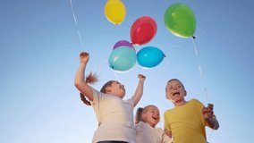 group of children jumping with balloons jumping rejoice. happy family holiday kid dream concept. children hugging jumping against the blue sky lifestyle holding balloons - Powered by Shutterstock - Get 15% off with code: PIKWIZARD15