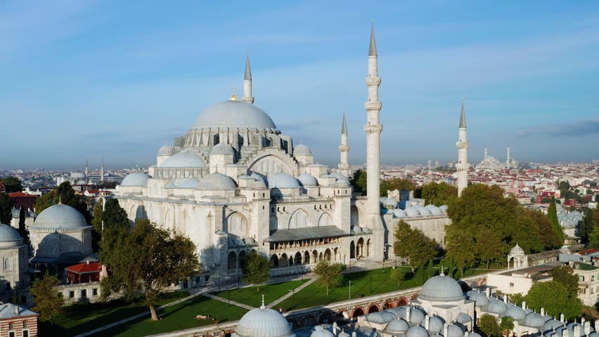 A breathtaking flypast view showcasing the iconic Suleymaniye Mosque in Istanbul, Turkey. Its distinctive minarets pierce the skyline, exuding historical significance and architectural brilliance Royalty-Free Stock Footage #1108408469
