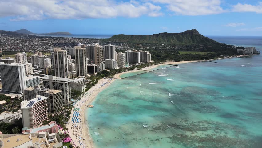 An aerial drone footage of Waikiki beach with Diamond Head monument during daytime in Hawaii