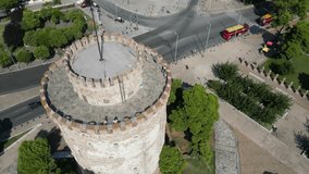 An aerial video of White Tower of Thessaloniki on the sea shore in Greece