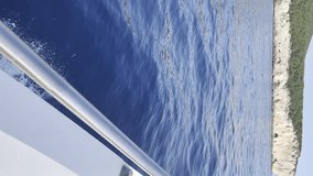vertical video point of view from a boat of people on holiday sailing in the sea in Sardinia