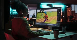 Zoom in Portrait of Black Female Video Game Designer Creating Metaverse and Design Video Game Character in Creative Office at Night. Focused Woman Working on a New 3D Level on Her Desktop Computer