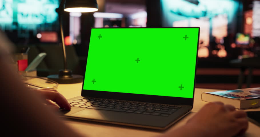 Close Up on Anonymous Designer Working on a Laptop Computer with Mock Up Green Screen Chromakey Display with Isolated Placeholder. Video Template for Artistic Content Creation and Presentations Royalty-Free Stock Footage #1108413443