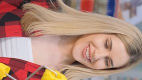 Portrait of a beautiful girl holding a paint roller and laughing at the camera. Vertical video - Powered by Shutterstock - Get 15% off with code: PIKWIZARD15