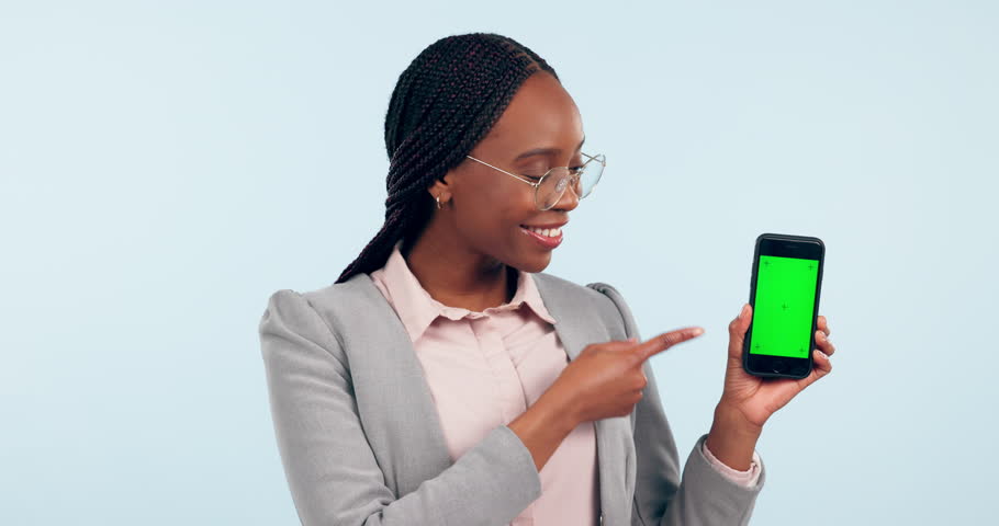 Happy black woman, phone and green screen with thumbs up in approval against a studio background. Portrait of African female person or business employee with like emoji, yes sign or OK for smartphone