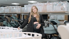 Pregnant Woman Choosing Baby Baby Bed In Shop. Preparing to Become Mother - Powered by Shutterstock - Get 15% off with code: PIKWIZARD15