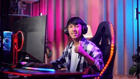 Asian Teen Boy Gamer Smiling To Camera And Showing Thumb Up While Playing Video Game On Computer
 - Powered by Shutterstock - Get 15% off with code: PIKWIZARD15
