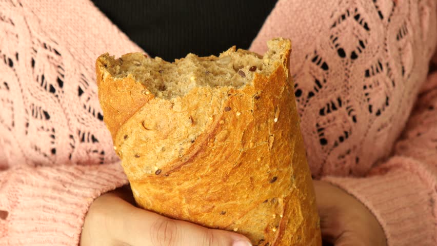 women hand breaking breads closeup 