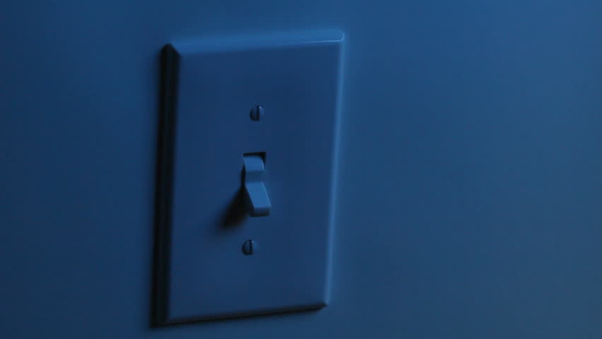 A women's hand flips a light switch on, and then turns it off. Two different