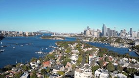 Sydney, Australia: Aerial drone footage of the famous Sydney bay and city skyline with the Sydney harbor bridge from the Balmain residential district.