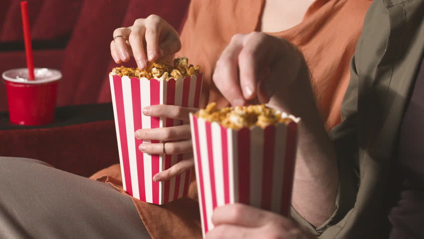 Close Up View Of Couple Hands Holding Popcorn In The Cinema Royalty-Free Stock Footage #1108443205