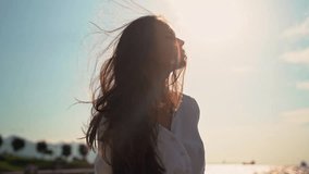 Relaxed girl woman breathing fresh air raising arms over sunset sky at summer seaside. Dreaming, freedom and traveling concept. Female mental health wellness - Powered by Shutterstock - Get 15% off with code: PIKWIZARD15