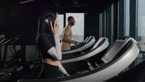 Female sportswoman athletic fit Caucasian sport woman walk slow on treadmill in fitness gym lazy unmotivated girl cardio exercise training talk mobile phone answer smartphone call on running machine - Powered by Shutterstock - Get 15% off with code: PIKWIZARD15